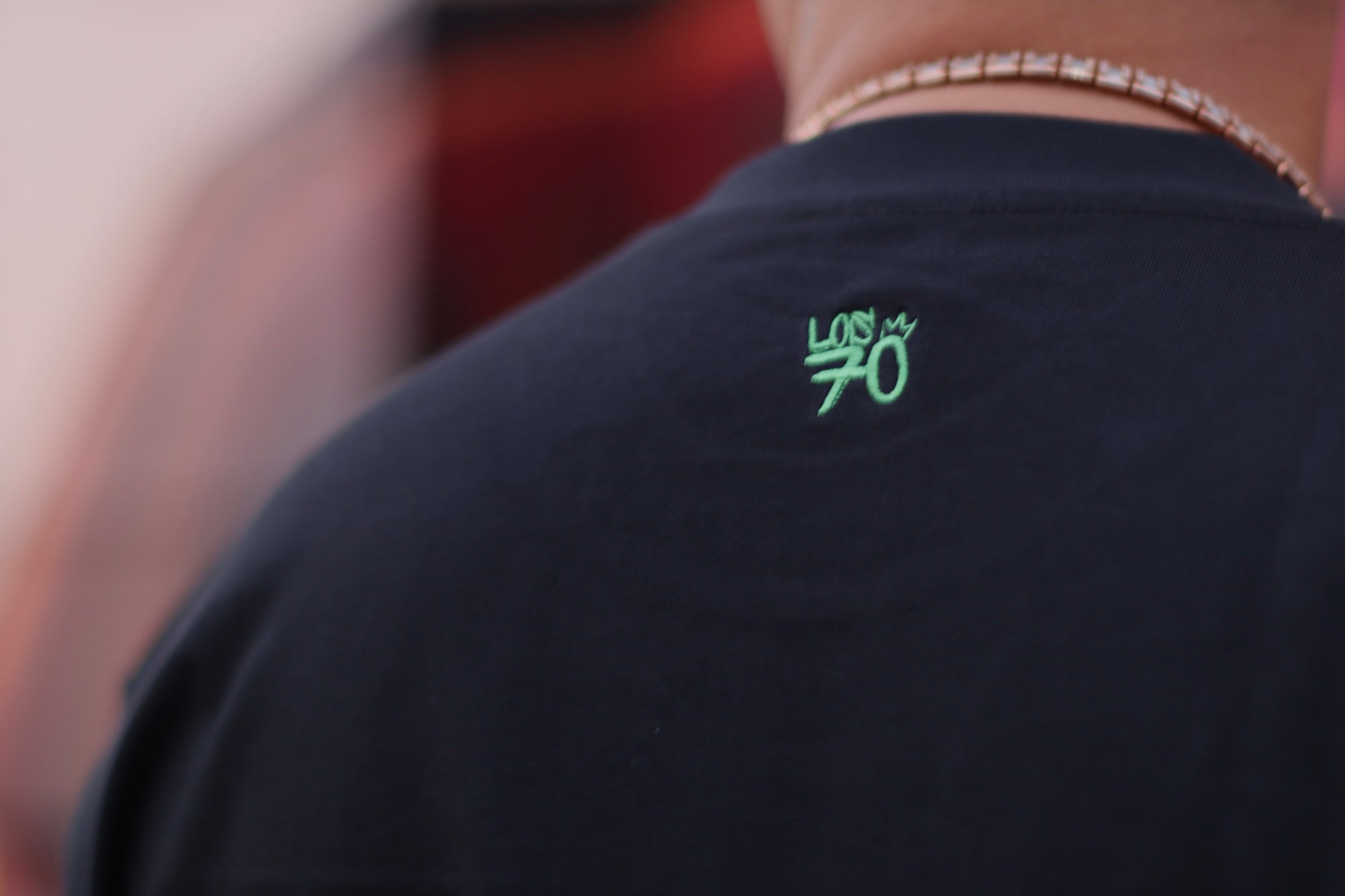 Black t-shirt with green logo