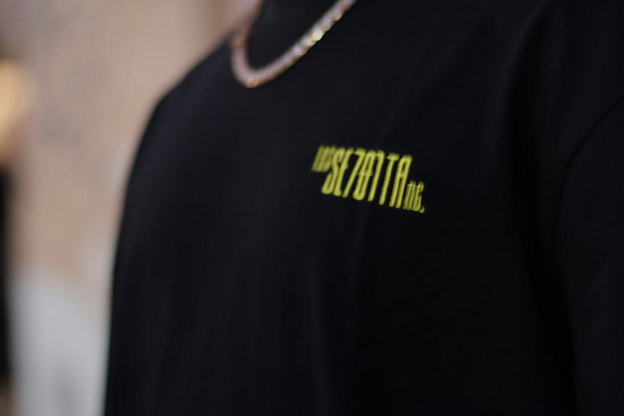 Black t-shirt with yellow logo