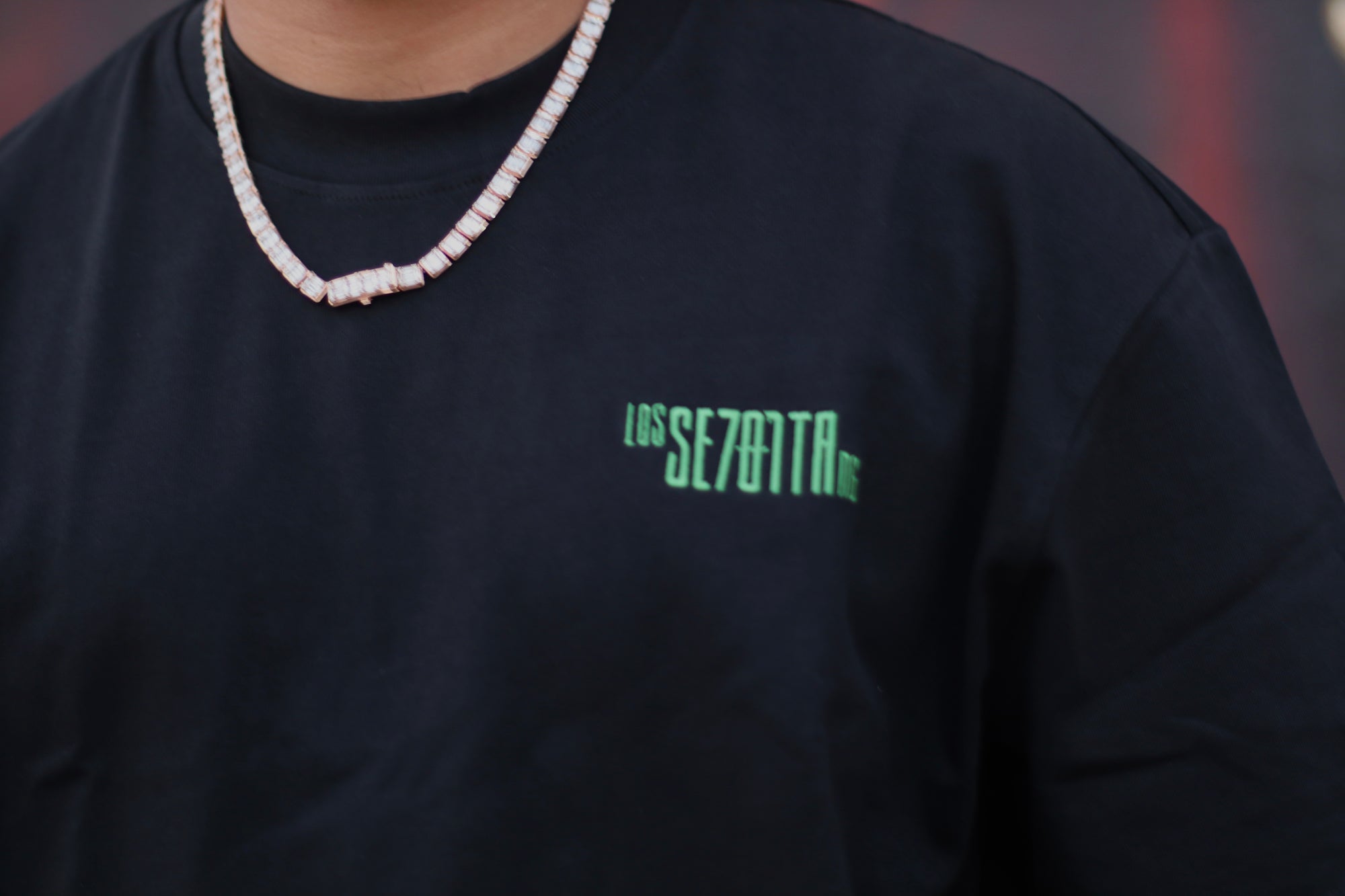 Black t-shirt with green logo