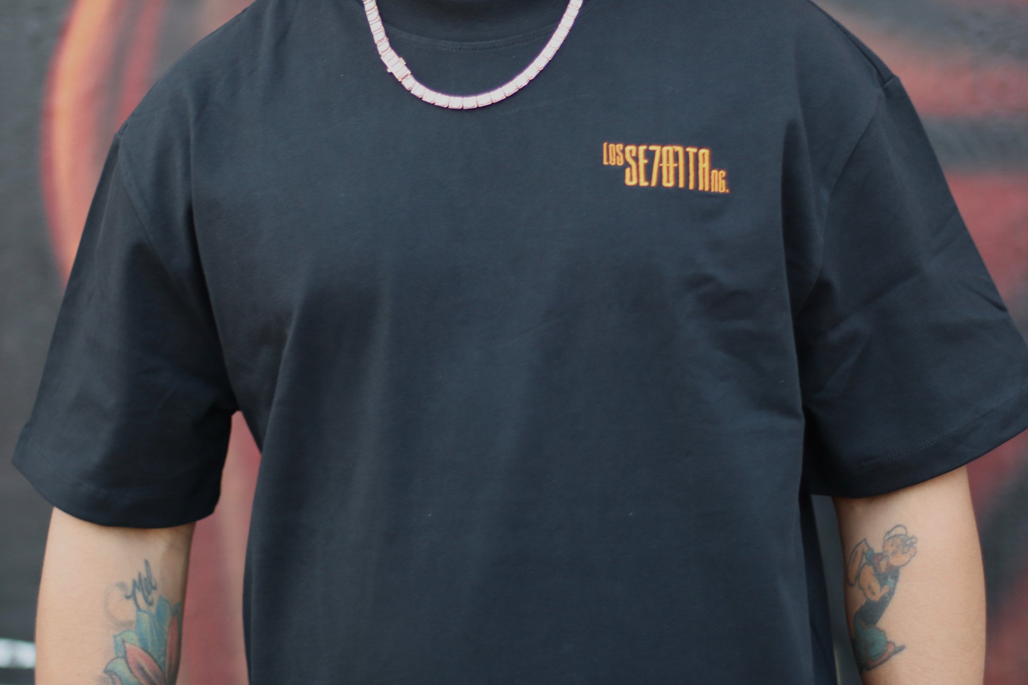 black t-shirt with orange logo