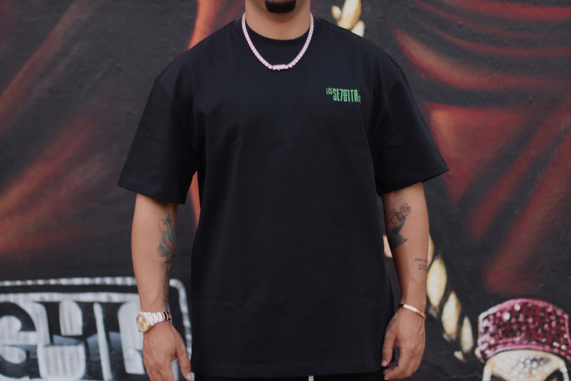 Black t-shirt with green logo